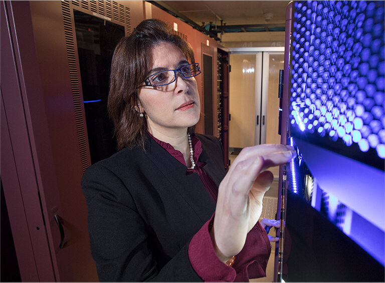 Business woman inspecting computer banks