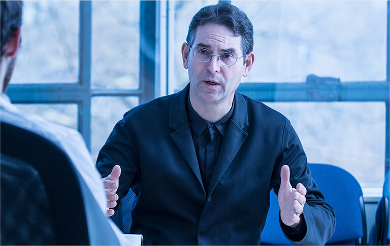 John D. Halamka, M.D. in business meeting