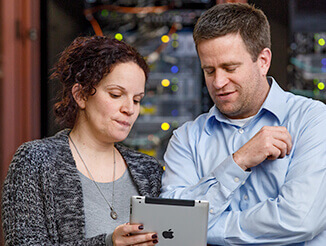 Man and woman looking at iPad